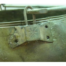 Dotted cross with rays on the hinge of metal situla